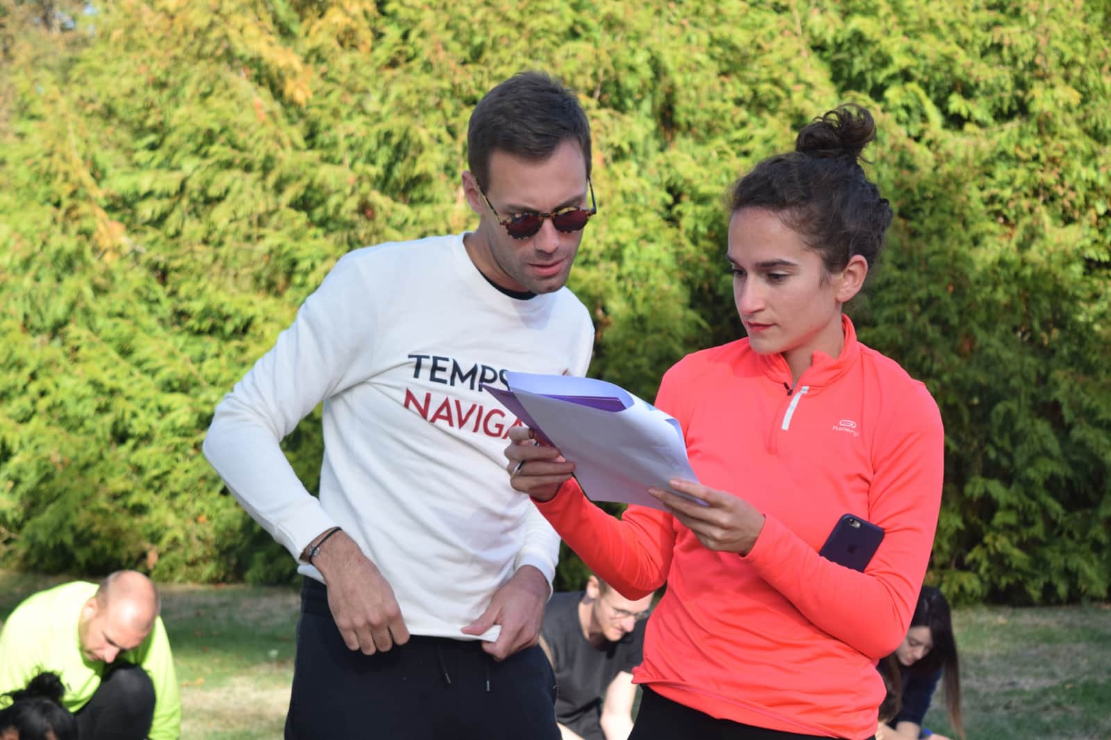 Deux participants réfléchissent ensemble à une épreuve dans le parc du Manoir